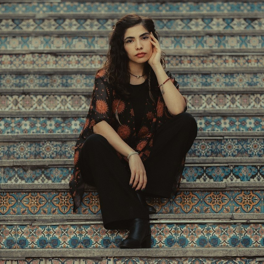 Homa sitting on mosaic steps.